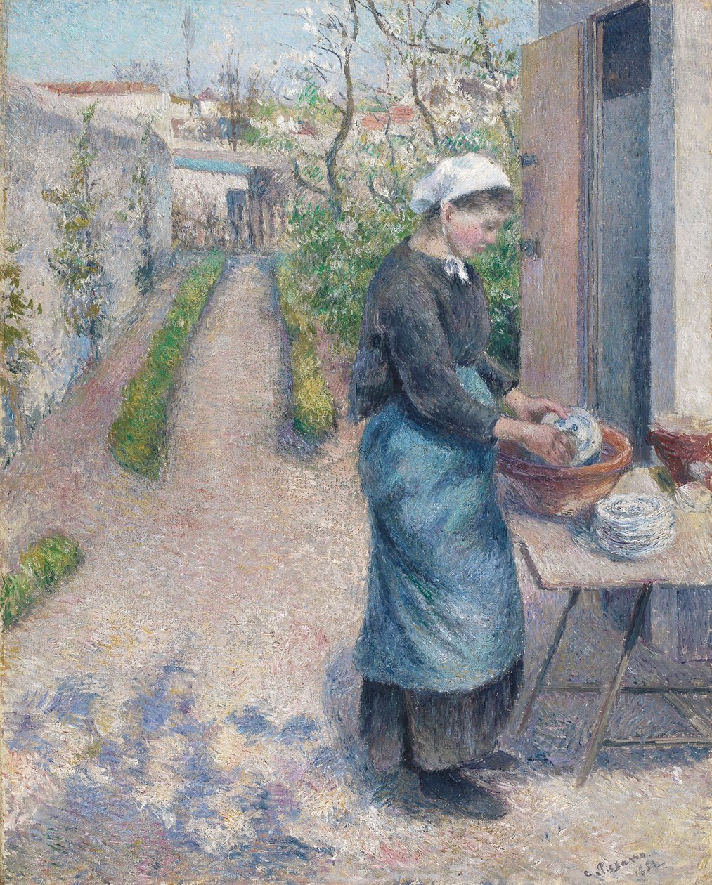 V zahradě v Pontoise: Mladá žena mycí nádobí, 1882 od Camille Jacob Pissarro