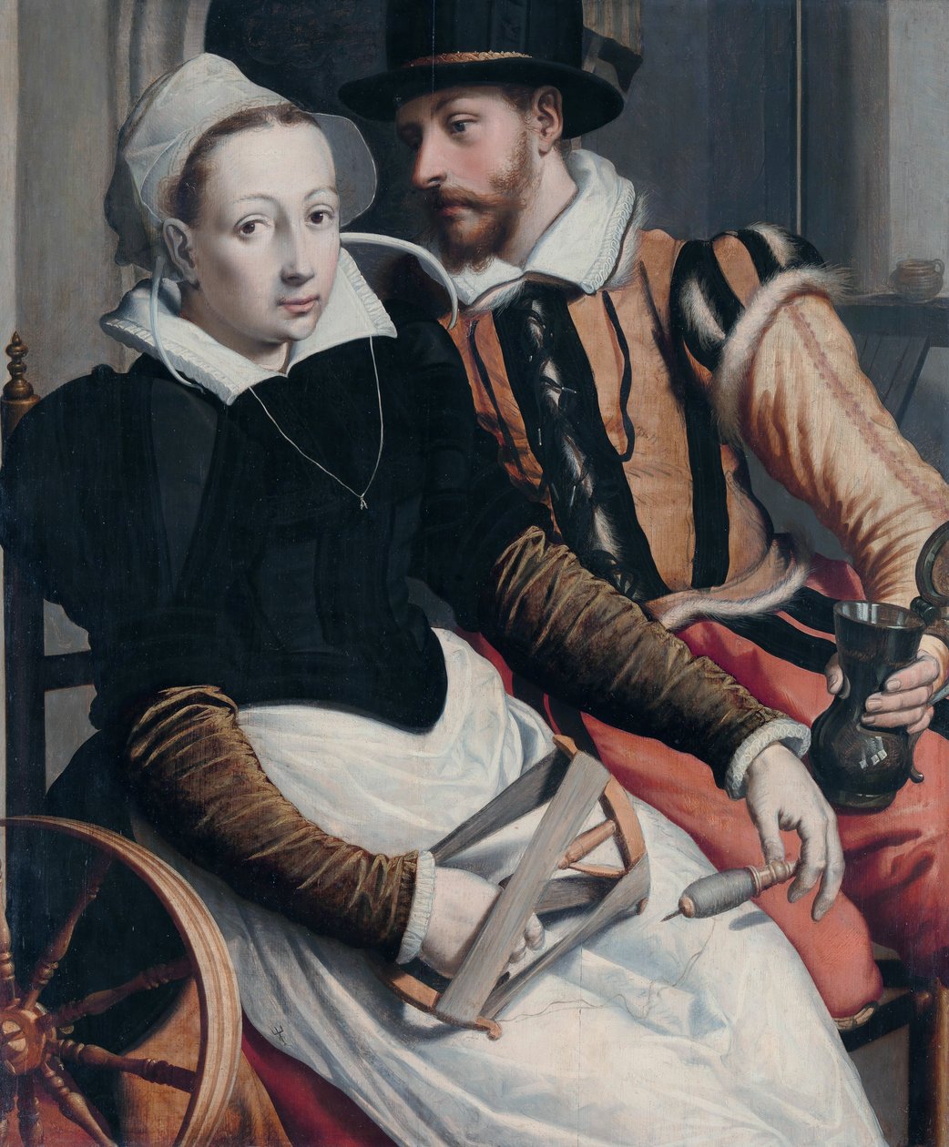 Žena u kolovratu a muž s hrnkem sedící v interiéru. od Pieter Pietersz the Elder